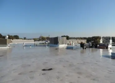 Exposed rooftop HVAC units on a commercial roof before screening is installed