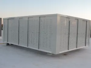 a finished light-gray louvered perforated-metal equipment screen enclosure on a white membrane roof