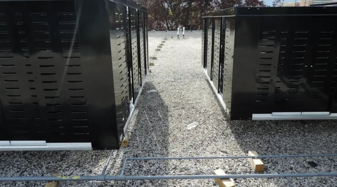 Black louvered metal roof screening systems on a gravel ballasted roof