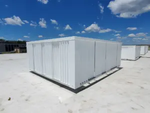 Completed white corrugated metal rooftop equipment screen enclosures on a commercial flat roof