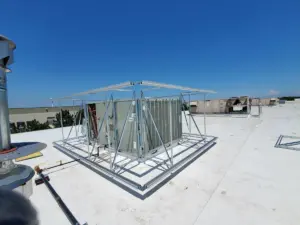 Aluminum support framework installed around rooftop HVAC units before equipment screen panels are added
